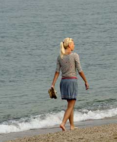 woman walks on beach